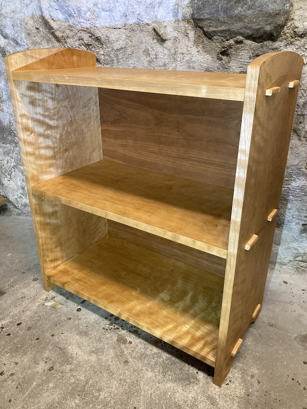 A bookcase made from cherry wood, with through tenons and finished with homemade shellac